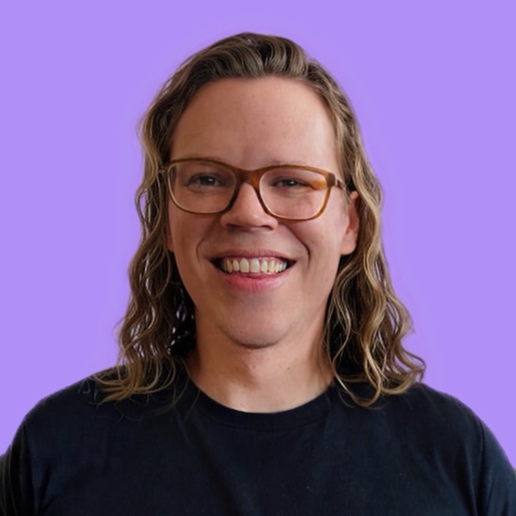 Photo of Jim Yencken smiling against a purple background